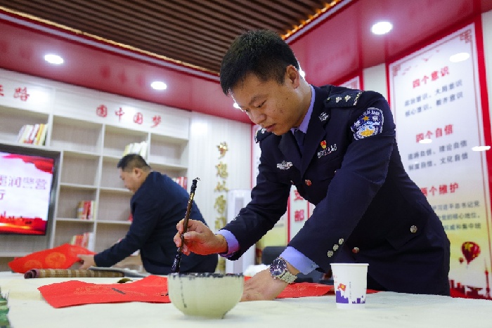 图为移民管理警察与书法家共同写书法 梅俊豪摄